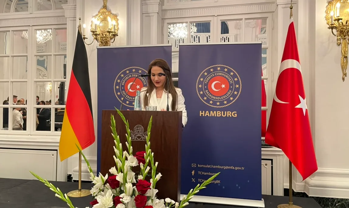 Muavin Konsolos Sultan Okatar resepsiyonda kürsüden konuşuyor.